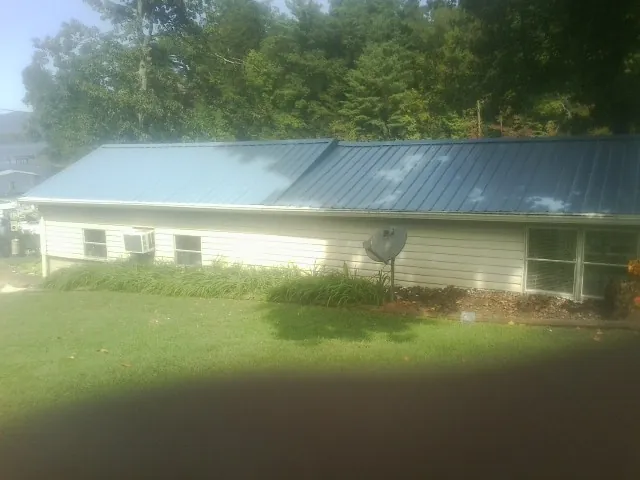 Blue metal roof running the length of a single story home in Rye